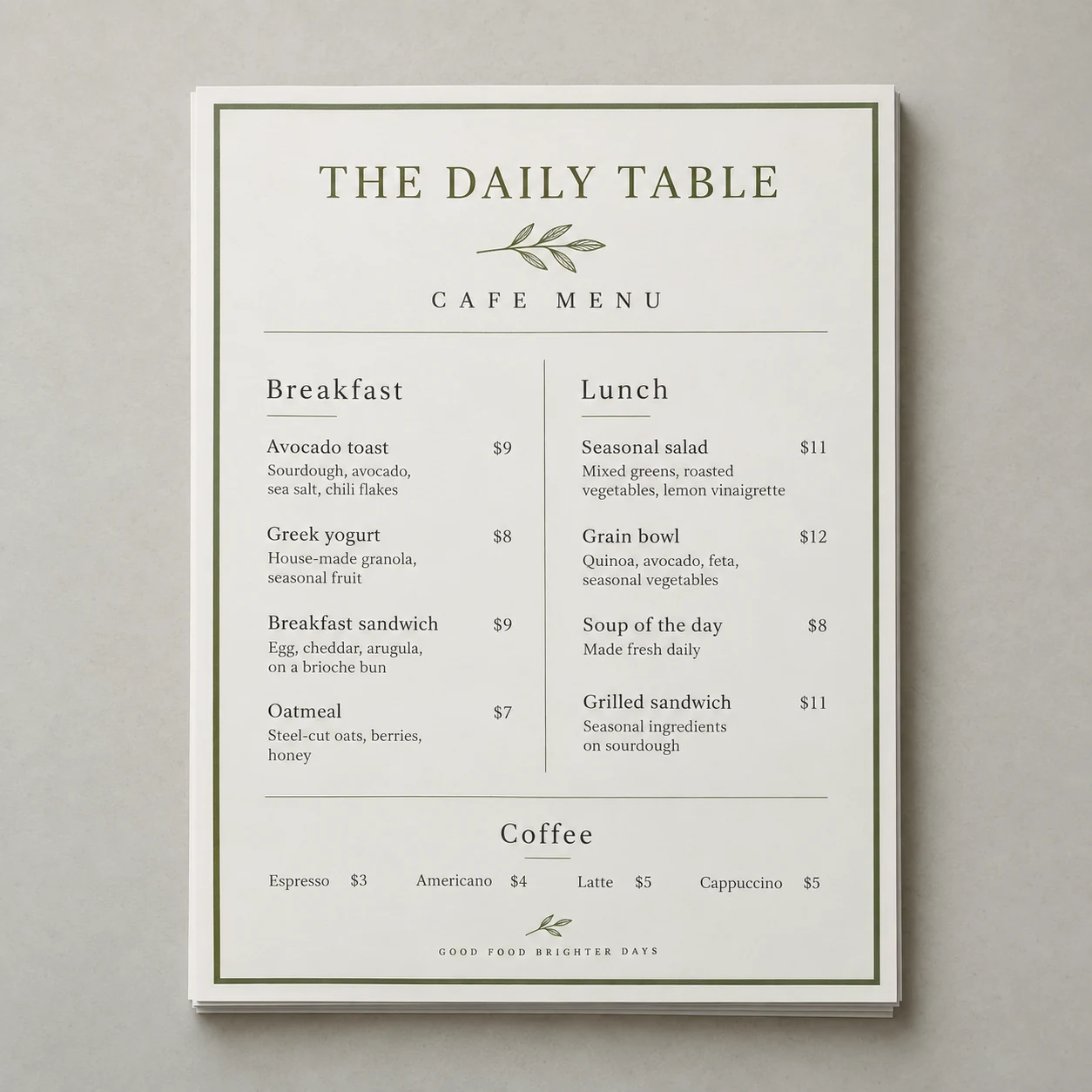 Printed cafe menus with an olive heading and a short food list photographed on a light studio surface